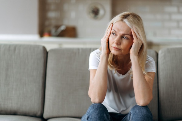 Sad woman sitting on couch 